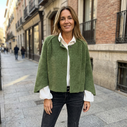 Sidewalk lifestyle photo of a European woman wearing the olive green jacket